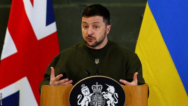 Ukraine president Volodymyr Zelensky gives a speech in front of the flags of Great Britain and Ukraine