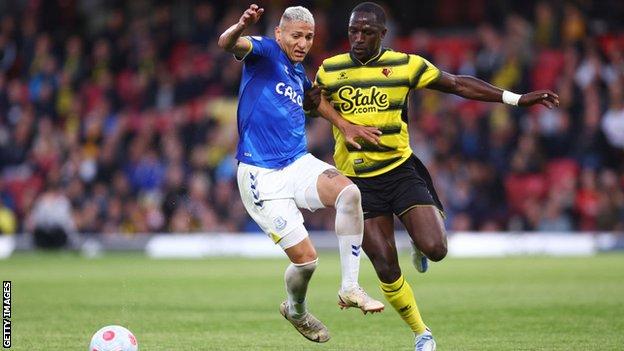 Richarlison and Moussa Sissoko battle for possession