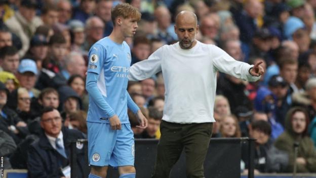 Cole Palmer (left) and Pep Guardiola