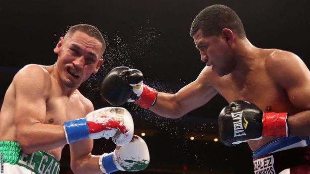 Roman Gonzalez of Nicaragua lands a right hook on Juan Francisco Estrada of Mexico during their WBC super flyweight title bout at Desert Diamond Arena on December 03, 2022 in Glendale, Arizona.