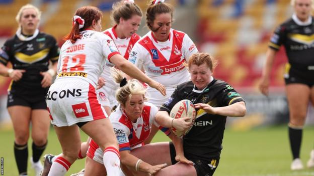 York and St Helens players collide with Liv Wood tackled by a plethora of Saints defenders
