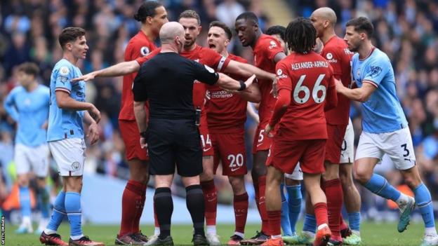 Liverpool players surround referee Simon Hooper