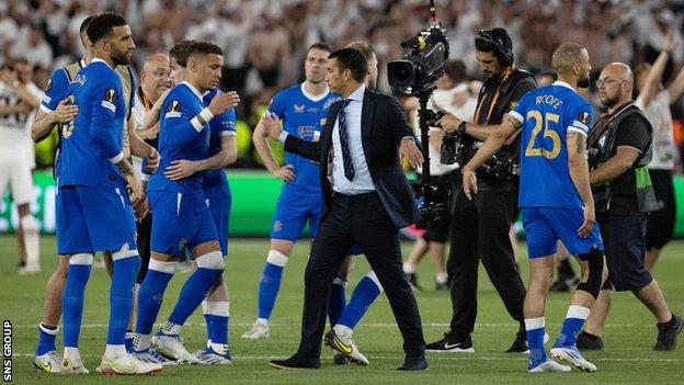 Rangers' James Tavernier (L) with manager Giovanni van Bronkhorst are left dejected at full time during the UEFA Europa League Final between Eintracht Frankfurt v Rangers at the Ramon Sanchez Pizjuan Stadium