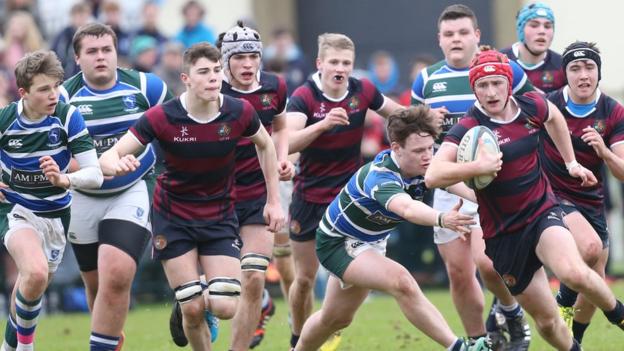 Mathew Borne of Belfast Royal Academy makes a break during his side's 31-14 victory over Grosvenor in the second round of the Ulster Schools' Cup