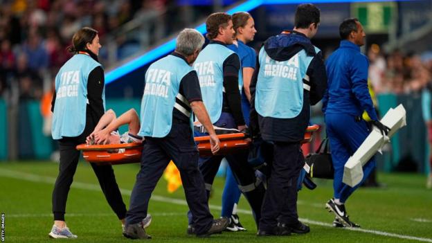 Keira Walsh is carried off on a stretcher during the match with Denmark