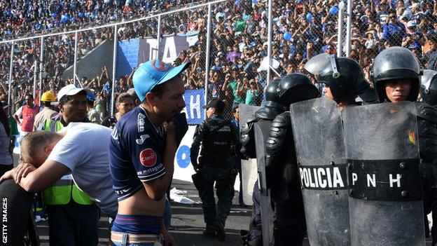 Fans reacts following a stampede during the game between Motagua and Honduras Progreso