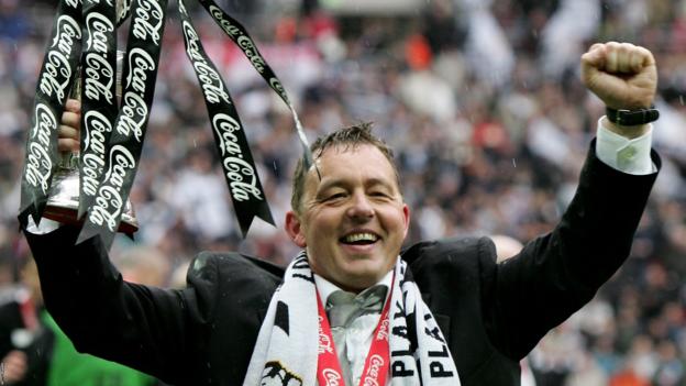 Billy Davies holds the Championship trophy aloft after winning the play-off