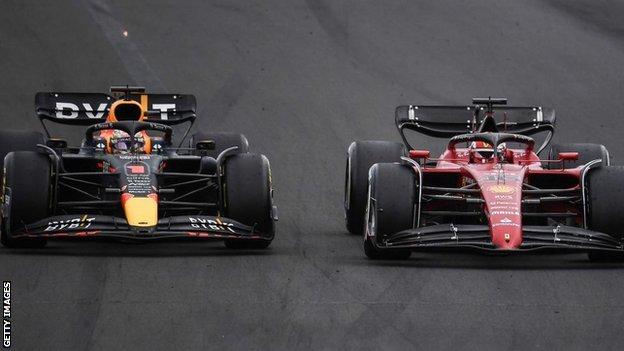 Red Bull Racing's Dutch driver Max Verstappen (L) and Ferrari's Monegasque driver Charles Leclerc compete during the Formula One Hungarian Grand Prix at the Hungaroring in Mogyorod near Budapest, Hungary, on July 31, 2022