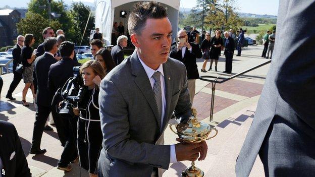Rickie Fowler carries the Ryder Cup Trophy as he arrives for a memorial service for golfer Arnold Palmer