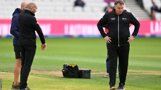 Groundstaff and umpires at Headingley look sceptically at the pitch