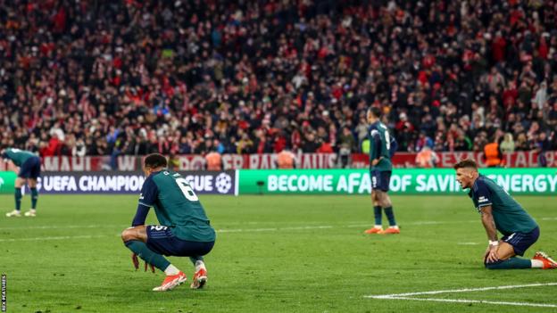 Arsenal's players react after losing to Bayern Munich in the Champions League