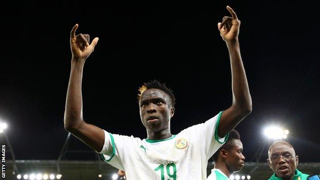 Senegal's Youssouph Badji raises his arms in celebration