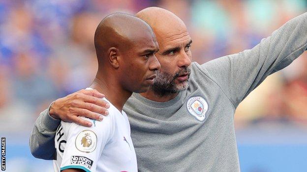 Manchester City manager Fernandinho and the club's manager Pep Guardiola