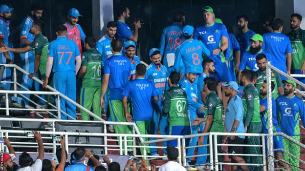 India and Pakistan players shake hands after their Asia Cup match is abandoned because of rain