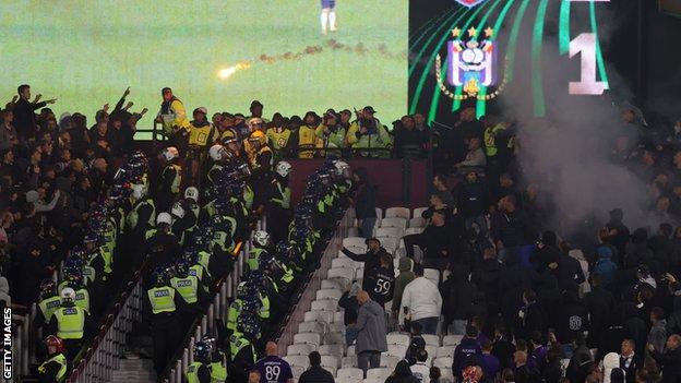Anderlecht and West Ham fans throw seats and objects at each other during the Europa Conference League game