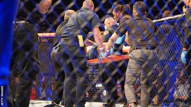 Chris Weidman (centre on stretcher)