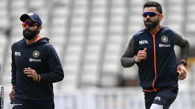 Virat Kohli trains with his team-mates