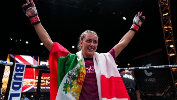 Dakota Ditcheva celebrates victory by holding a Bulgarian and English flag