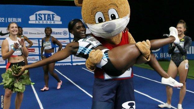 Daryll Neita is held aloft by the mascot after winning the women's 60m at ISTAF Berlin