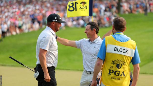 Michael Block and Rory McIlroy on the 18th green at Oak Hill