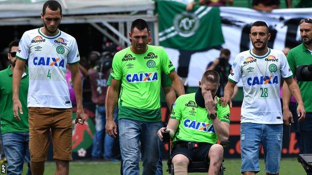 Helio Neto (L), Jackson Follmann (2nd-R) and Alan Ruschel (R), survivors of the LaMia airplane crash in Colombia, arrive at the Arena Conda stadium in Chapeco,