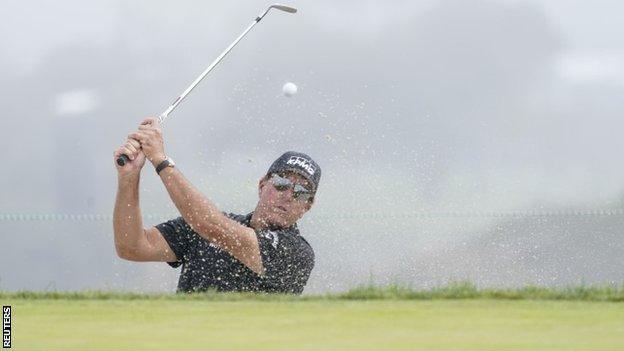 Phil Mickelson hitting out of a bunker during a practice round at Torrey Pines