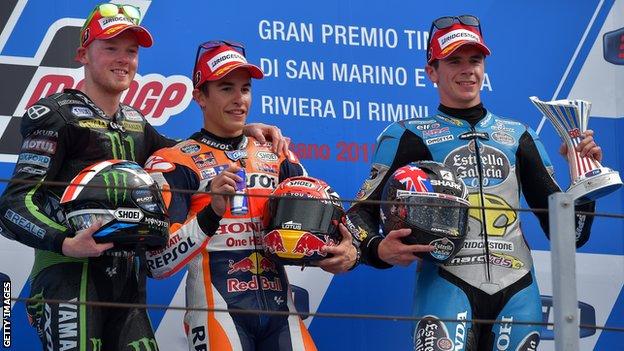 Spaniard Marc Marquez (centre) celebrates his San Marino Moto GP victory on the podium with Honda team-mate Scott Redding (right) and Yamaha's Bradley Smith