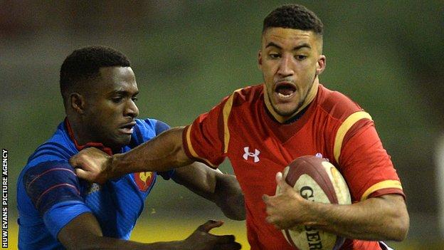 Wales and Ospreys wing Keelan Giles (right) is tackled by Eliott Roudil of France