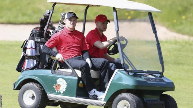 Wayne Rooney and Tom Cleverley ride a buggy on a charity golf day at Dunham Forest Golf Club