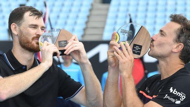 Jamie Murray and Bruno Soares kiss their trophies for winning last week's Great Ocean Road Open