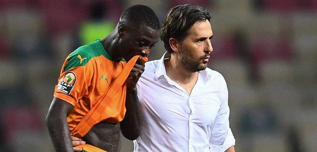 Nicolas Pepe is consoled by Ivory Coast coach Patrice Beaumelle after the final whistle