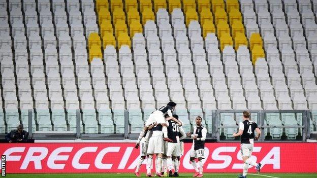 Juventus celebrate a goal in their match against Inter Milan, which was played without fans in the stadium