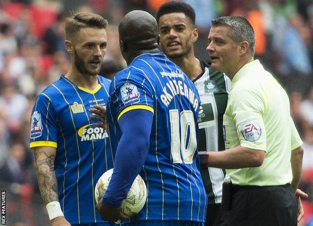 Akinfenwa took the ball off Callum Kennedy after a brief discussion