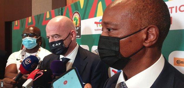 Gianni Infantino and Patrice Motsepe speak to reporters