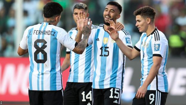 Argentina players celebrating a goal against Bolivia