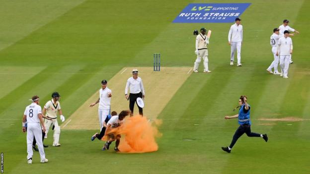 A protester is rugby tackled to the ground by security