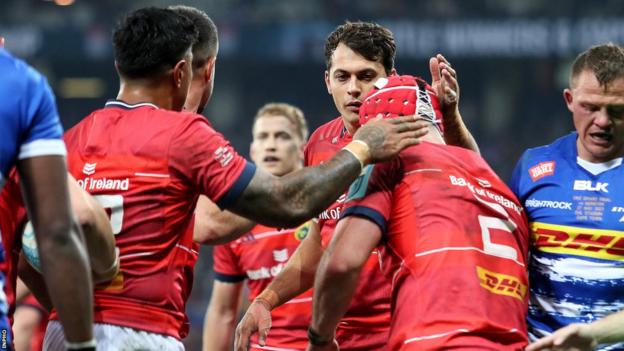 Munster try-scorer Diarmuid Barron is congratulated
