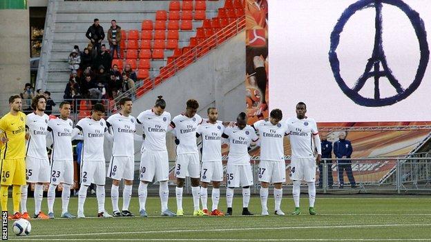 Paris St Germain players observe a minute's silence ahead of their win at Lorient