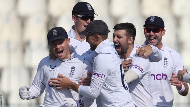 England players celebrate after Mark Wood takes a wicket