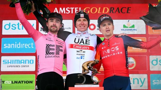 Cyclists Ben Healy (left), Tadej Pogacar (centre) and Tom Pidcock (right) on the podium of Amstel Gold Race