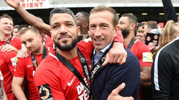 Justin Edinburgh (right) celebrates with Jobi McAnuff as Leyton Orient win promotion in April