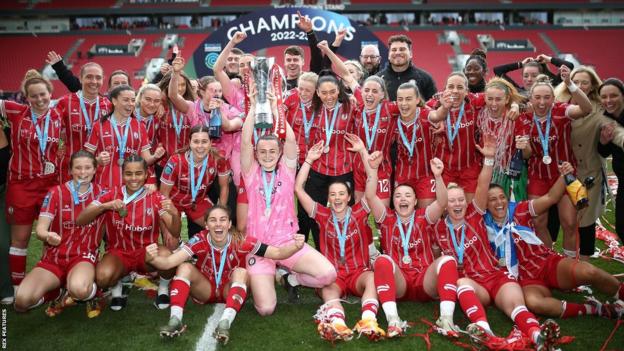 The Bristol City players and staff group together as Fran Bentley (centre) holds aloft the Championship trophy after their promotion is secured