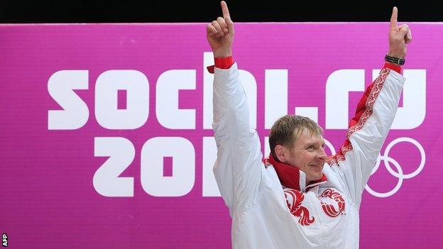 Bobsleigher Aleksandr Zubkov celebrates winning a gold medal at Sochi 2014