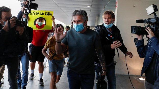 Jorge Messi walking through a Barcelona airport after returning from Argentina