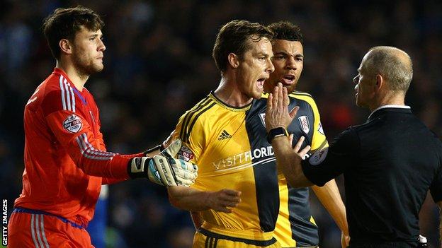 Fulham players Marcus Bettinelli, Scott Parker, Ryan Fredericks and referee Andy Woolmer