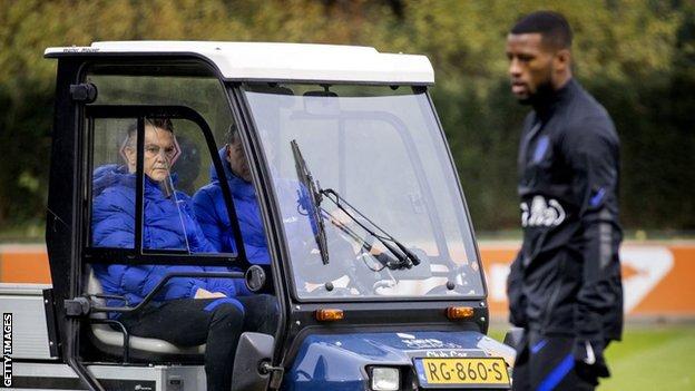 Louis van Gaal watching Netherlands training from a golf cart after he injured his hip