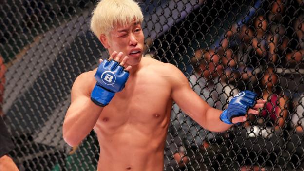 Makoto Takahashi gestures to his eye which is injured