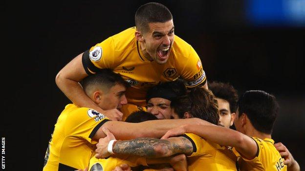 Wolves captain Conor Coady and the rest of the Wolves team celebrate with Raul Jimenez after his winner against West Ham on Saturday