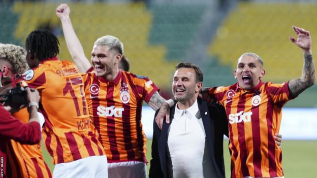 Galatasaray players celebrate the end of the Turkish Super Cup after Fenerbahce players left the pitch