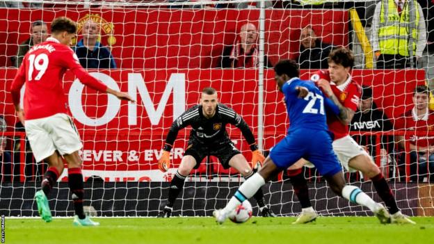 Manchester United goalkeeper David De Gea prepares to rescue Chelsea
